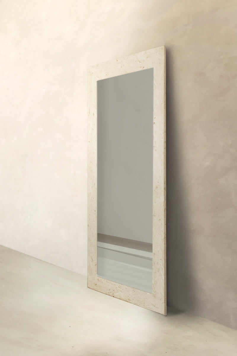 The Marbella Floor Mirror showcases a spacious rectangular shape with a light travertine stone frame, designed to lean elegantly against walls and complement minimalistic interiors.