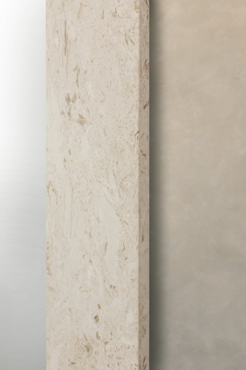A close-up of the Marbella Floor Mirror showcases two surfaces: one with a light beige, travertine-inspired texture and the other featuring a smooth, muted tan finish, displayed side by side.