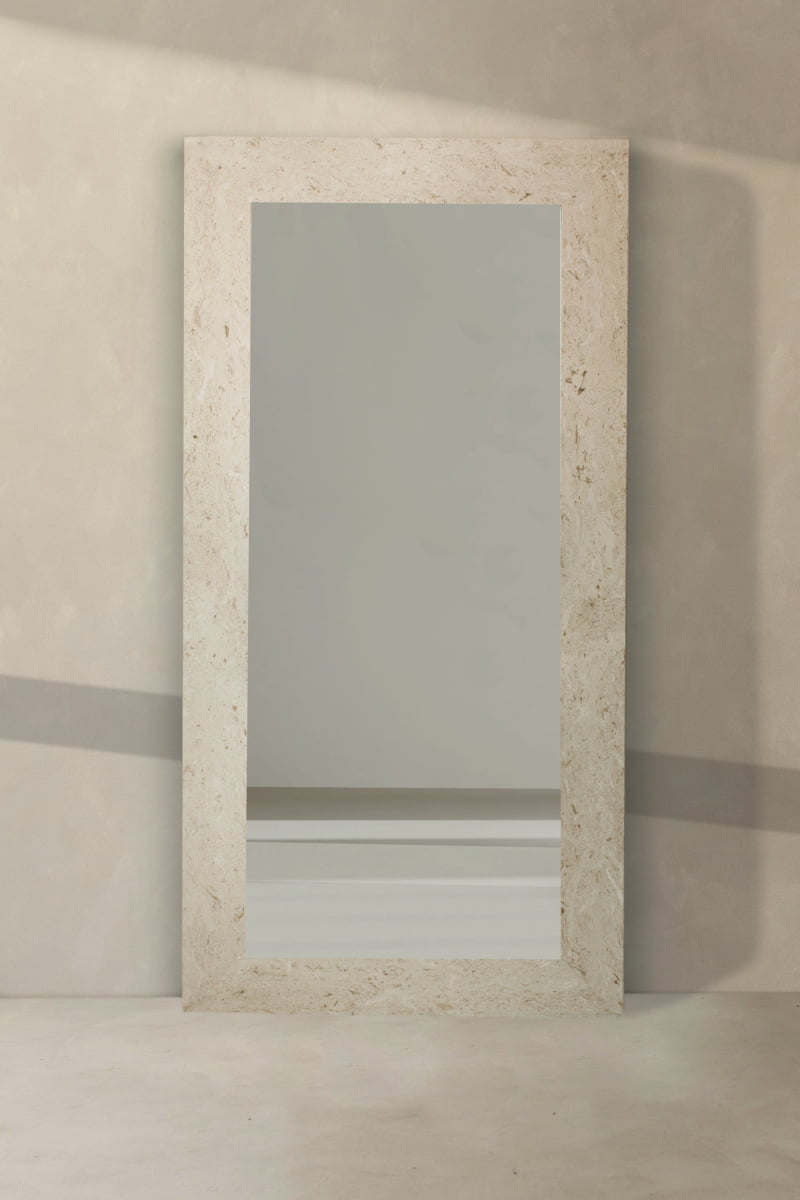 The Marbella Floor Mirror features a large rectangular silhouette and a light travertine stone frame, providing an elegant statement piece for your space.