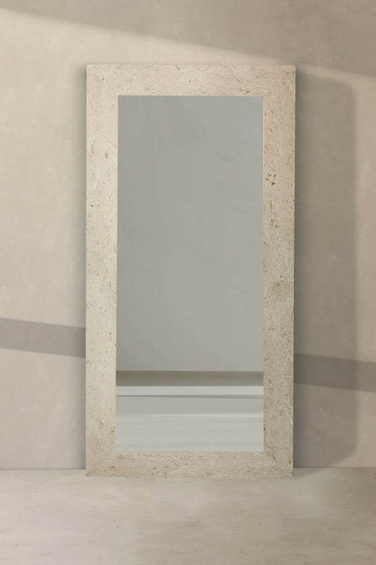 The Marbella Floor Mirror features a large rectangular silhouette and a light travertine stone frame, providing an elegant statement piece for your space.