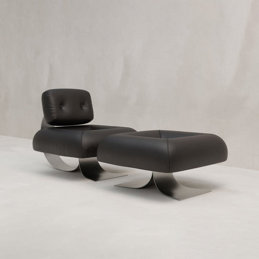The Paolo Chair With Ottoman features modern black leather and a sleek bent metal base, set on a plain light gray background—an ideal, sophisticated addition to any contemporary space.