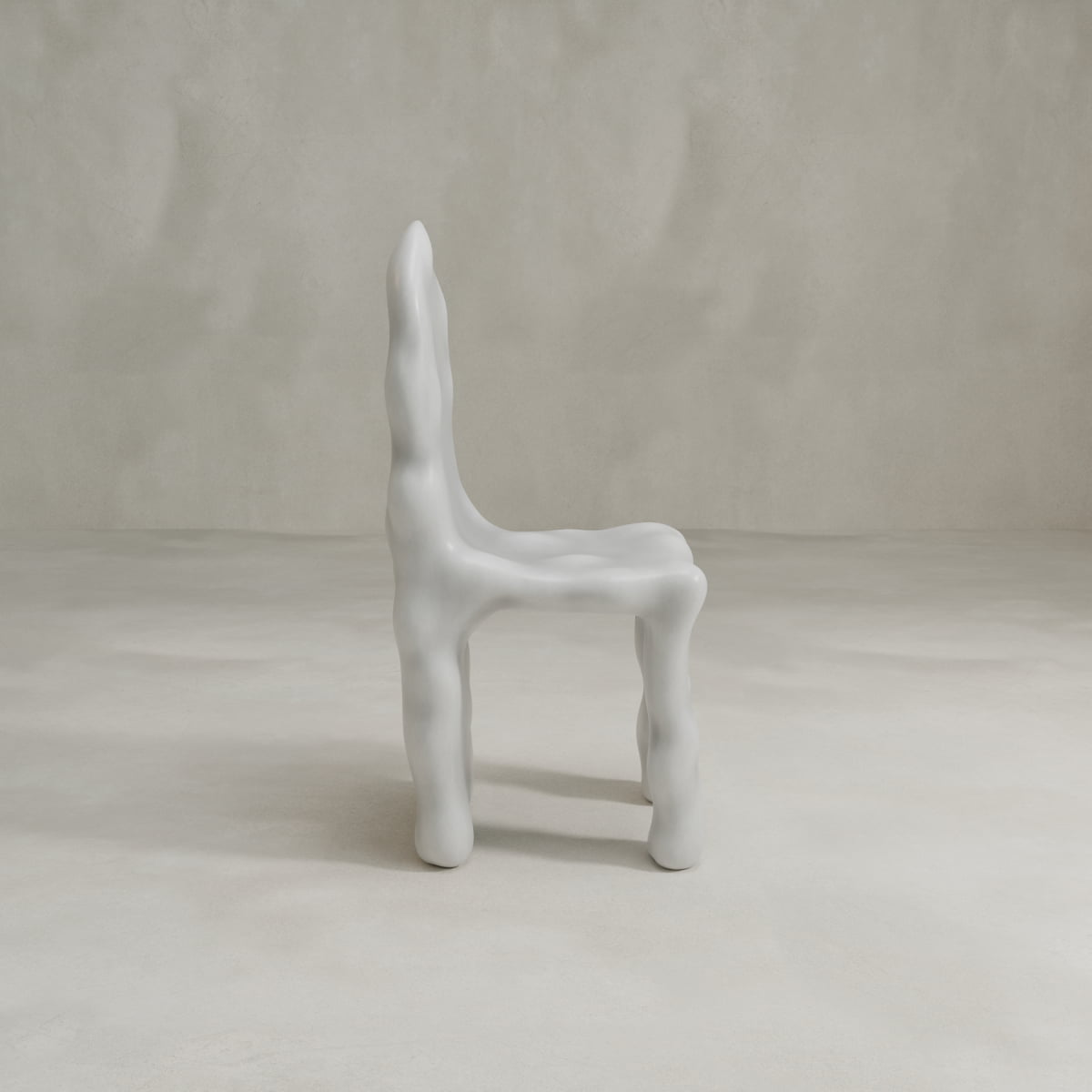 The Phantom Chair features an organic, wavy silhouette and a smooth white finish, highlighting modern craftsmanship as it stands on a neutral floor with a plain, light background.