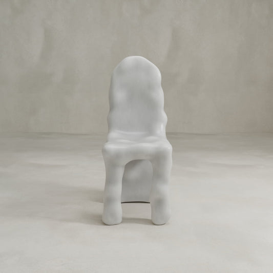The Phantom Chair showcases modern craftsmanship with its smooth, wavy surface and organic form in glossy white, elegantly displayed against a light minimalist background.