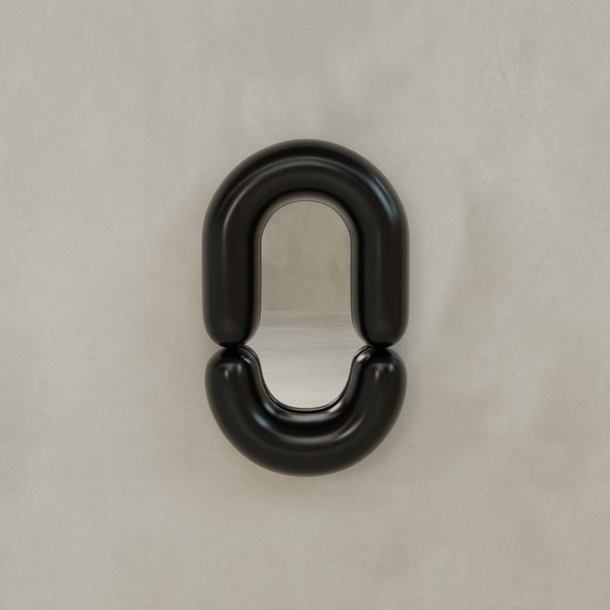 The Pitti Mirror In Medium features a modern oval shape with a thick, glossy black frame split into two halves, creating a striking statement on any plain light beige wall.