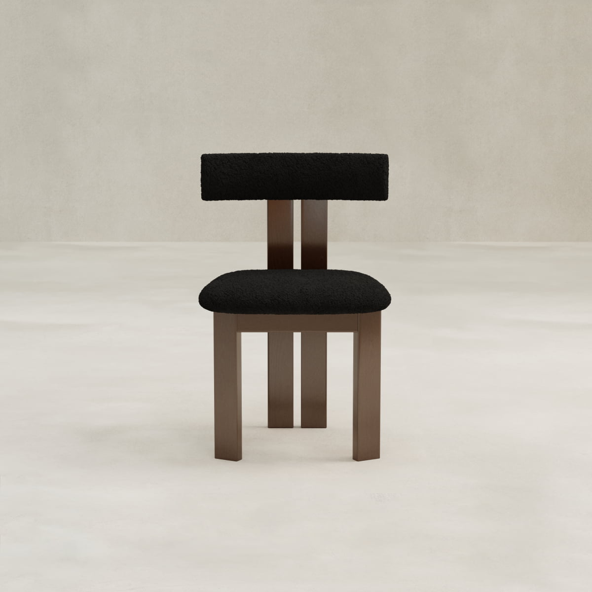 The Radley Dining Chair features a dark wood frame and black bouclé-cushioned seat and backrest, shown on a light floor against a beige wall for comfort and style.