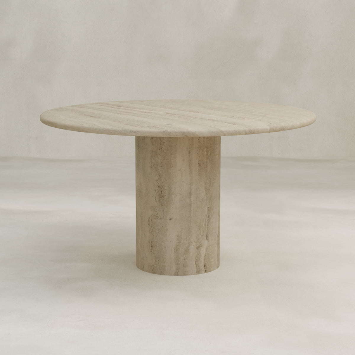 The Renè + Templeton Dining Set features a round, minimalist travertine dining table with a smooth, light stone top and a thick cylindrical pedestal base, styled against a neutral, textured backdrop.