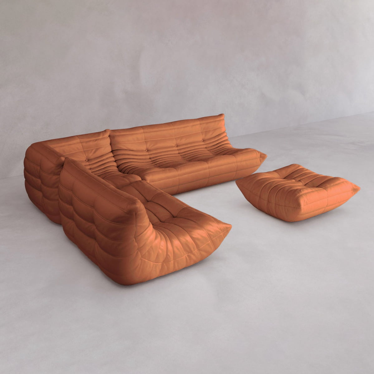 The Rolo Lounge Four Piece Sofa, a modular, tufted orange set with matching ottoman, sits on a light grey floor. Its soft, rounded shapes and visible stitching give a subtle nod to mid-century design against a pale wall.