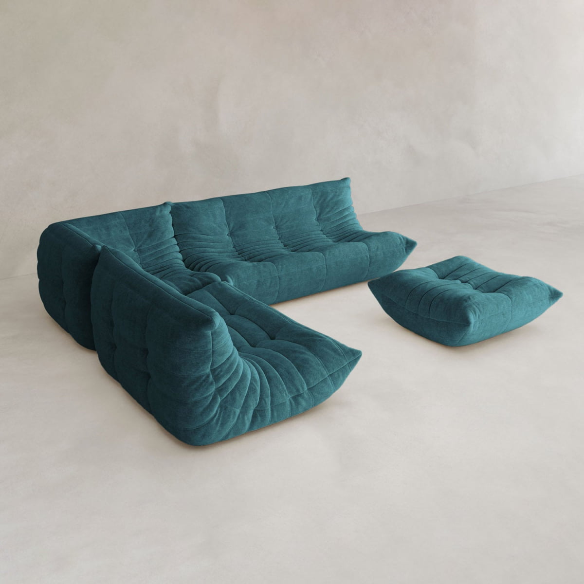The Rolo Lounge Four Piece Sofa, a modern teal sectional with tufted upholstery and mid-century design, comes with a matching floor cushion and stands out against a minimalist, light-colored background.