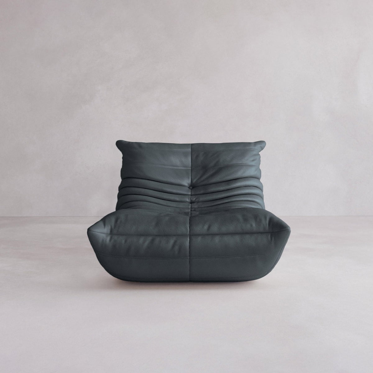 The Rolo Lounge Sofa Chair with Ottoman is a modern, low-profile black leather seat with horizontal pleats and mid-century inspiration, shown against a plain light gray background.