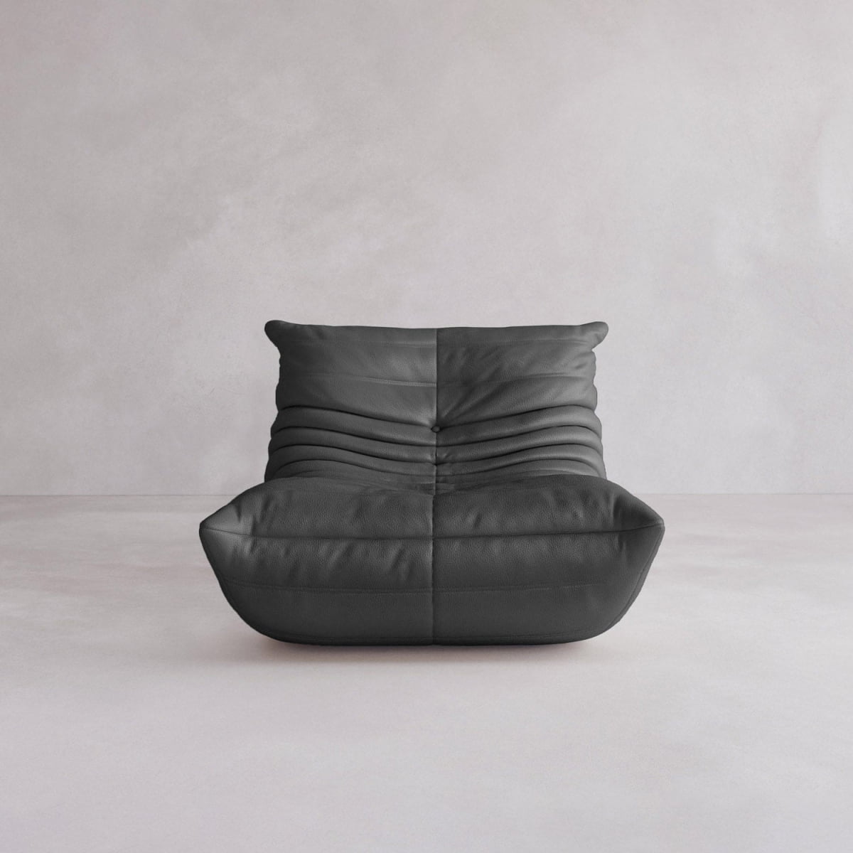 The Rolo Lounge Sofa Chair with Ottoman is a modern, armless black leather chair featuring deep horizontal tufting and a low seat, perfect for a mid-century vibe against a simple light gray wall and floor.