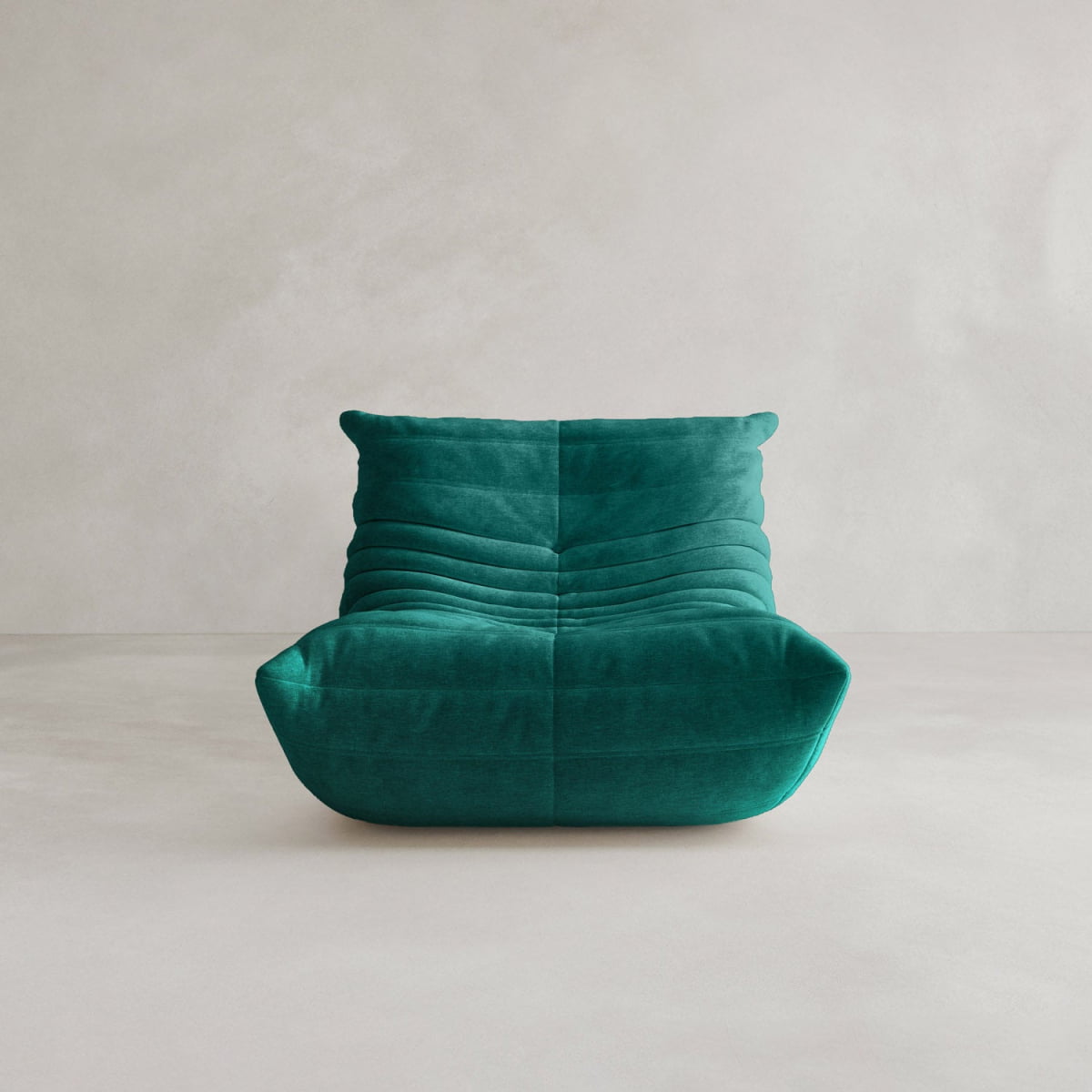 The Rolo Lounge Sofa Chair with Ottoman features a modern, armless design, low wide seat, and plush horizontal tufting in teal fabric for a 70s-inspired look, set against a neutral light background.