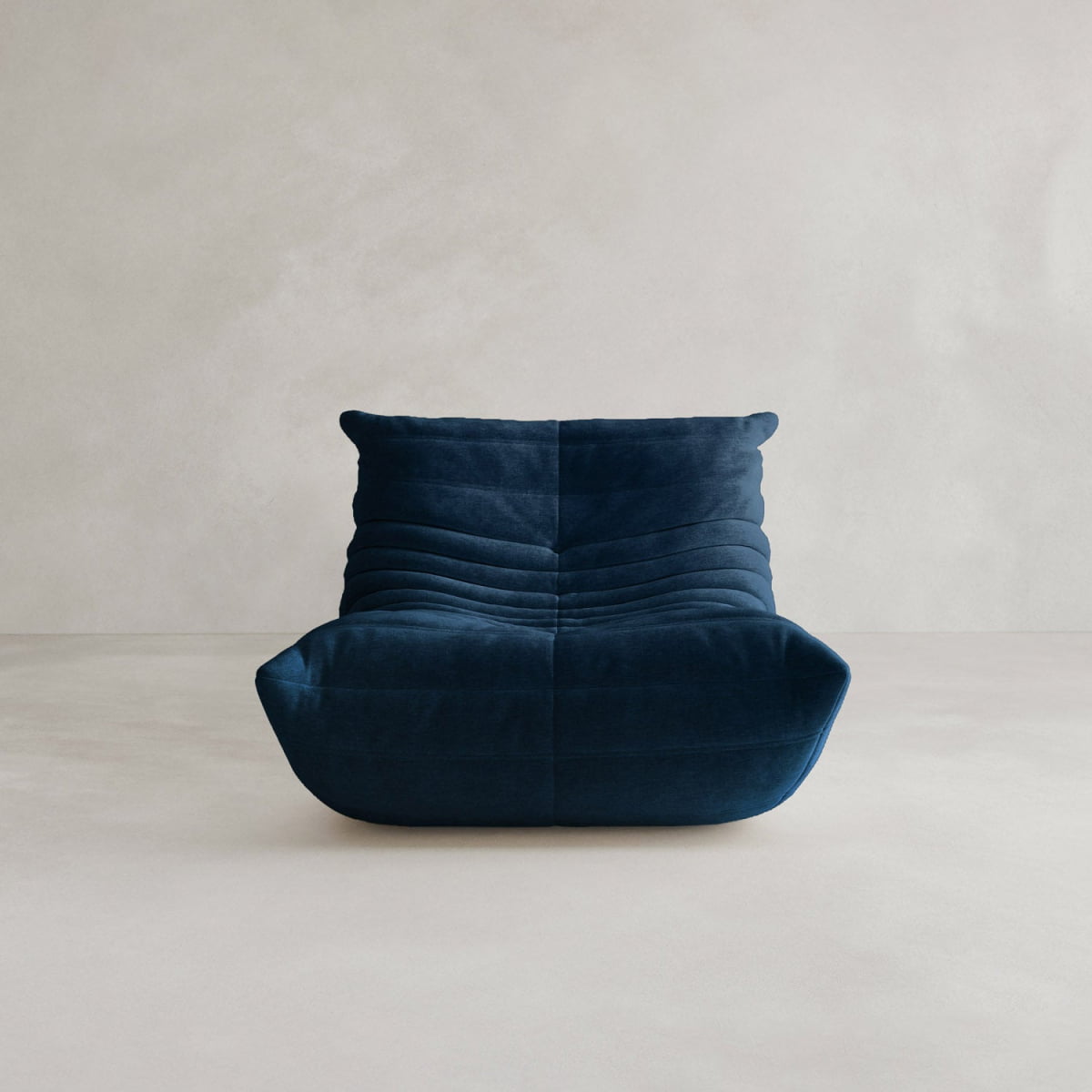 The Rolo Lounge Sofa Chair with Ottoman is a modern deep blue velvet chair with a low profile, wide seat, horizontal tufted stitching, and subtle mid-century accents, shown against a plain light gray background.
