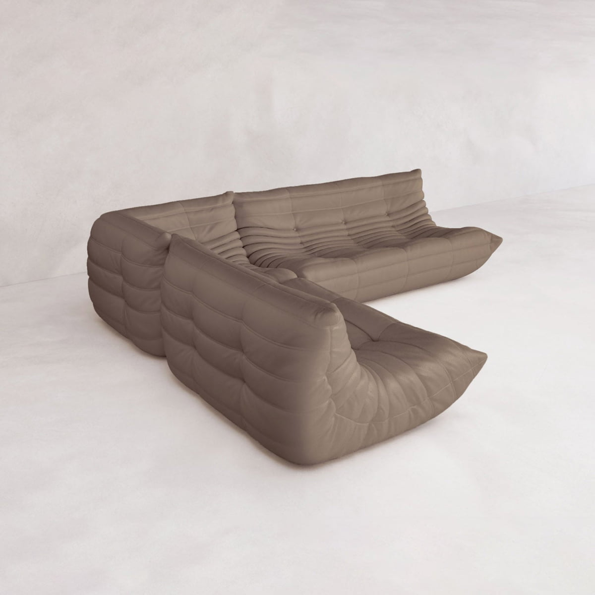 The Rolo Lounge Three Piece Sofa, a modern brown modular sectional with deep seats and tufted upholstery inspired by mid-century design, is arranged L-shaped against a light minimalist background.