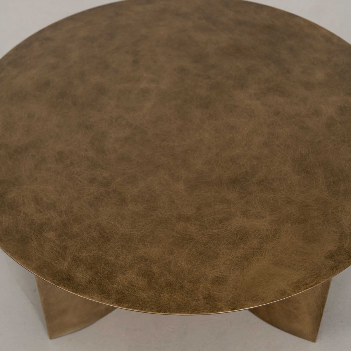The Roma Coffee Table Large is a round, metallic gold table with an elegant textured surface and sturdy curved legs, shown from above against a neutral background. A standout piece to elevate your decor.