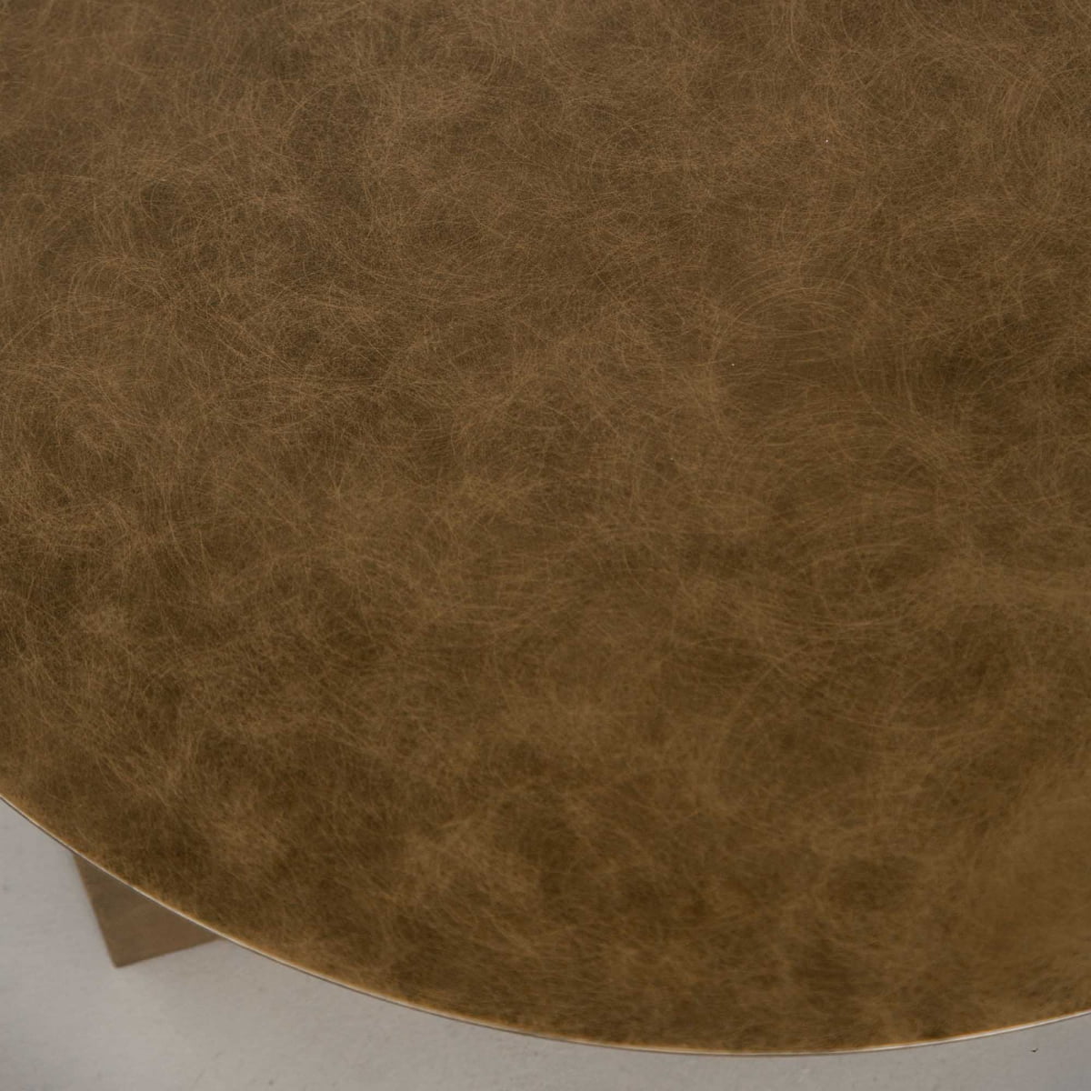 Close-up of the Roma Coffee Table Larges round tabletop, featuring a textured brown leather-like surface with natural variations and subtle markings—an elegant design that enhances any decor with its distinctive style.