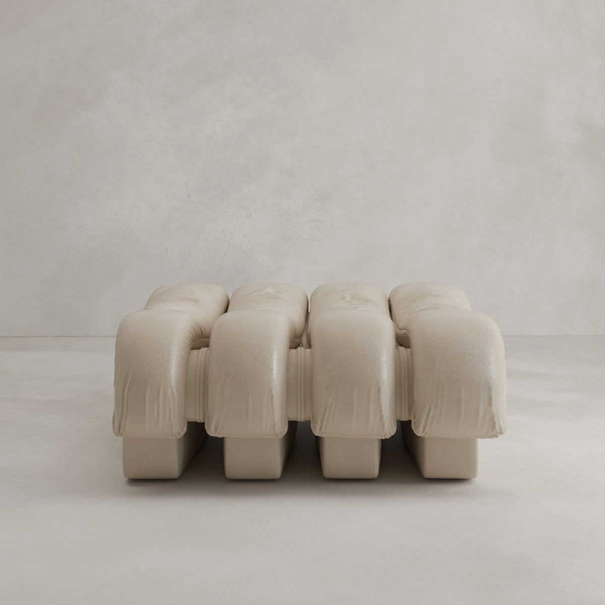 The Serpenti Sofa Ottoman is a modern, minimalist beige bench with three plush cushions and a textured finish, designed to seamlessly complement any modular setup, shown here against a plain light background.