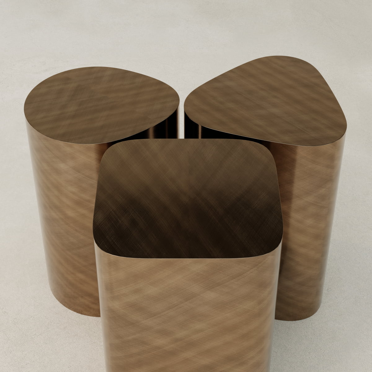 The Set of Solaris Side Table features three metallic bronze stools with circular, rounded square, and rounded triangle tops, offering minimalist design and modern luxury when grouped on a smooth, light surface.