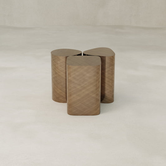 The Set of Solaris Side Table features a contemporary, minimalist design with three rounded rectangular wooden blocks joined together, displayed against a plain, light-colored background.