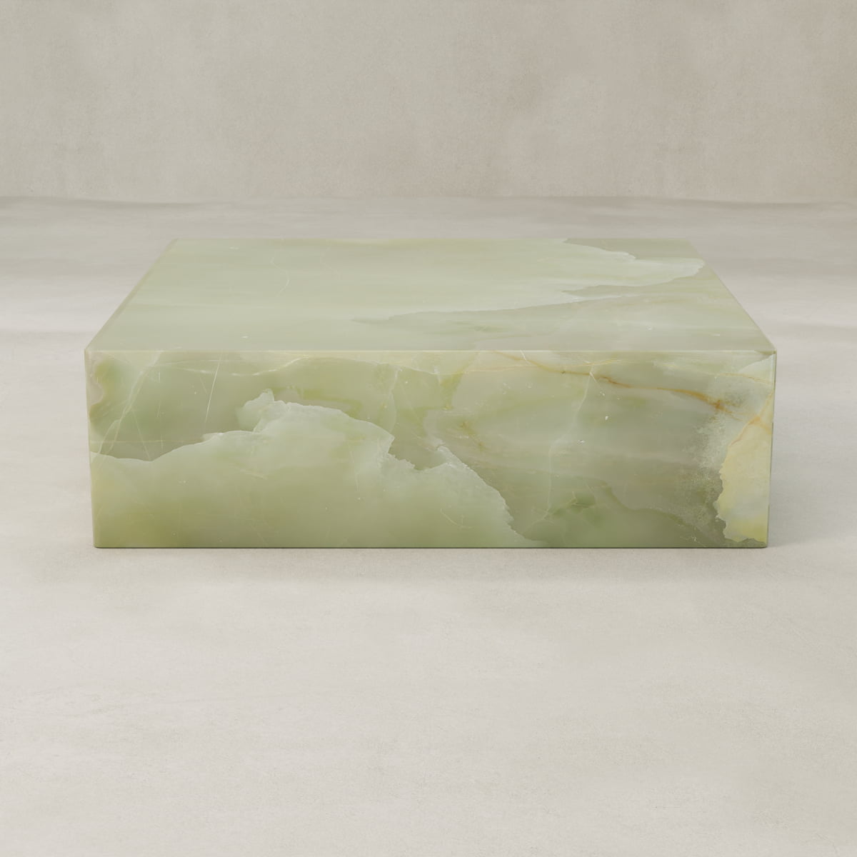 The Verdaine Onyx Coffee Table XL is a sculptural cube with a smooth, polished green onyx surface and natural veining set against a light beige background.