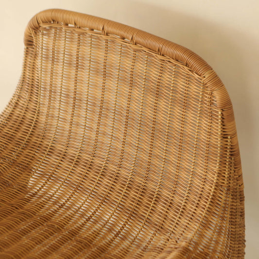 Close-up of the Wicker Chair, crafted from durable PU rattan in a light brown woven design—perfect for outdoor relaxation against a neutral-colored wall.