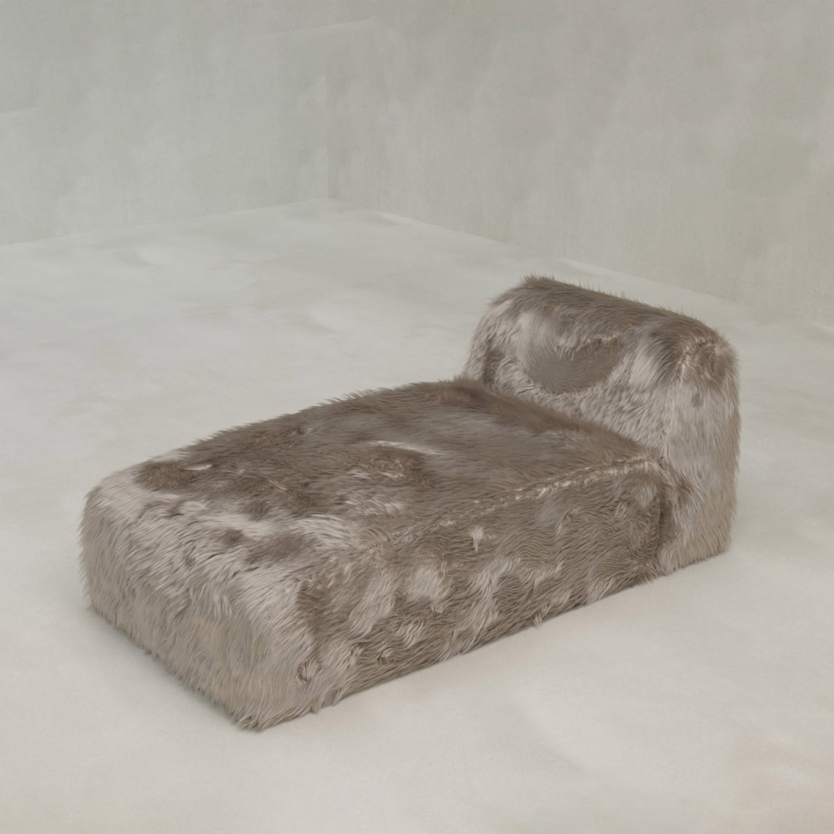The Yeti Chaise Lounge, covered in soft light brown faux fur, provides luxurious comfort and modern style in a minimalist room with pale walls and floor.