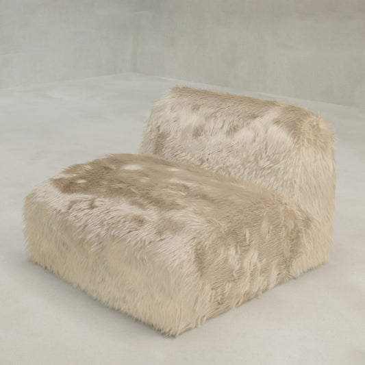 The Yeti One Seater Modular, a modern armless sofa with a low back, is fully upholstered in beige faux fur and set against a matching gray wall—ideal for any contemporary living space.