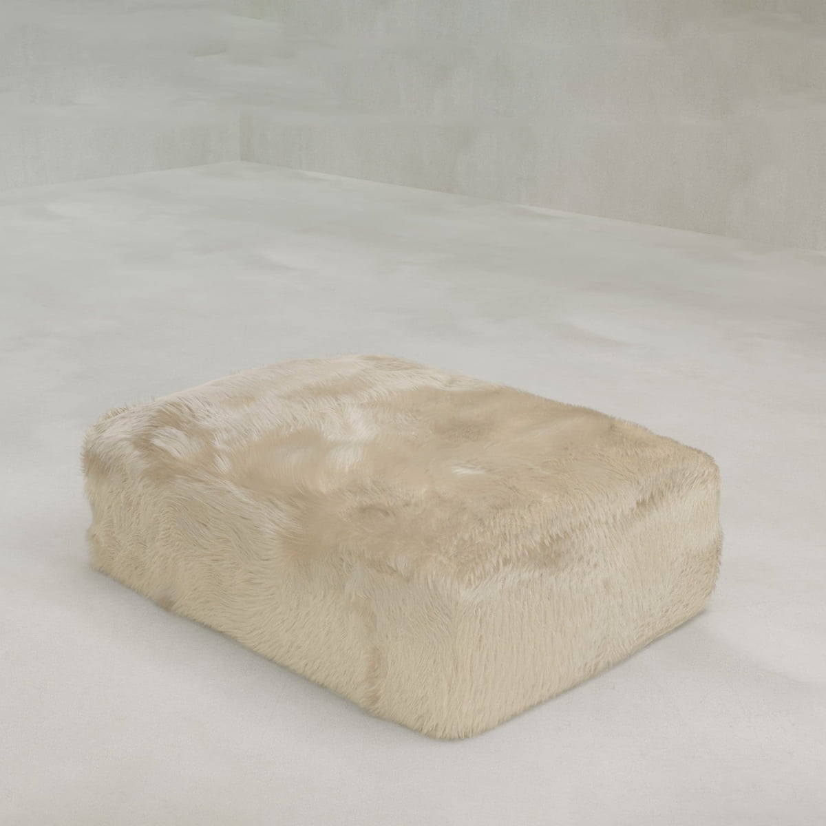 A large, rectangular Yeti Ottoman covered in plush faux fur rests on a smooth, light-colored floor against a plain, light background.