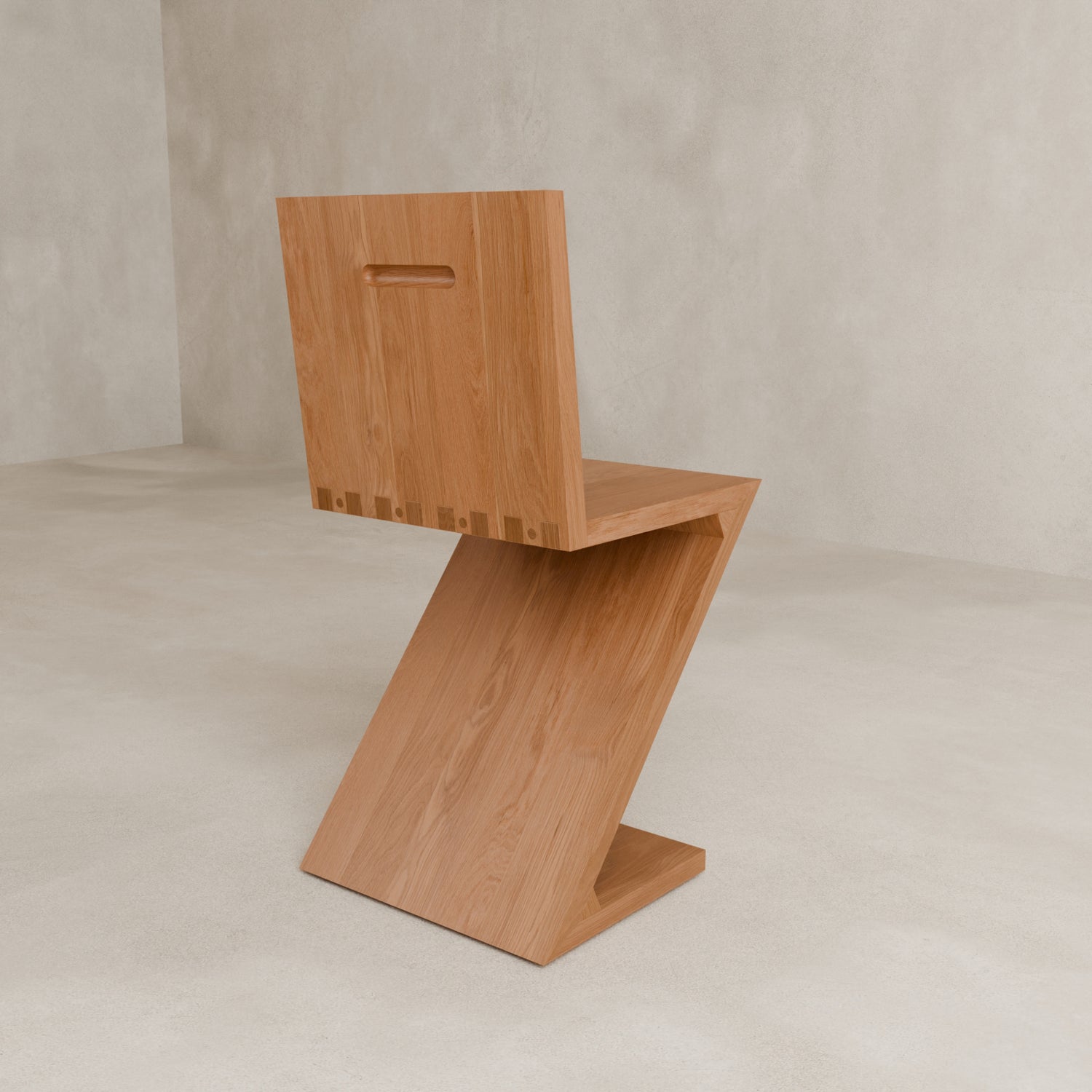 The Z Chair features a minimalist design with a rectangular cutout handle in the backrest, ideal for contemporary interiors. Shown on a light-colored floor against a neutral wall.