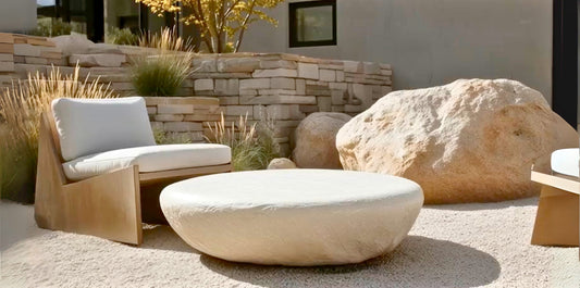Stone coffee table with organic design in polished marble, styled as a luxury coffee table and plinth accent table, showing how to decorate a coffee table with books, candles, and vases.