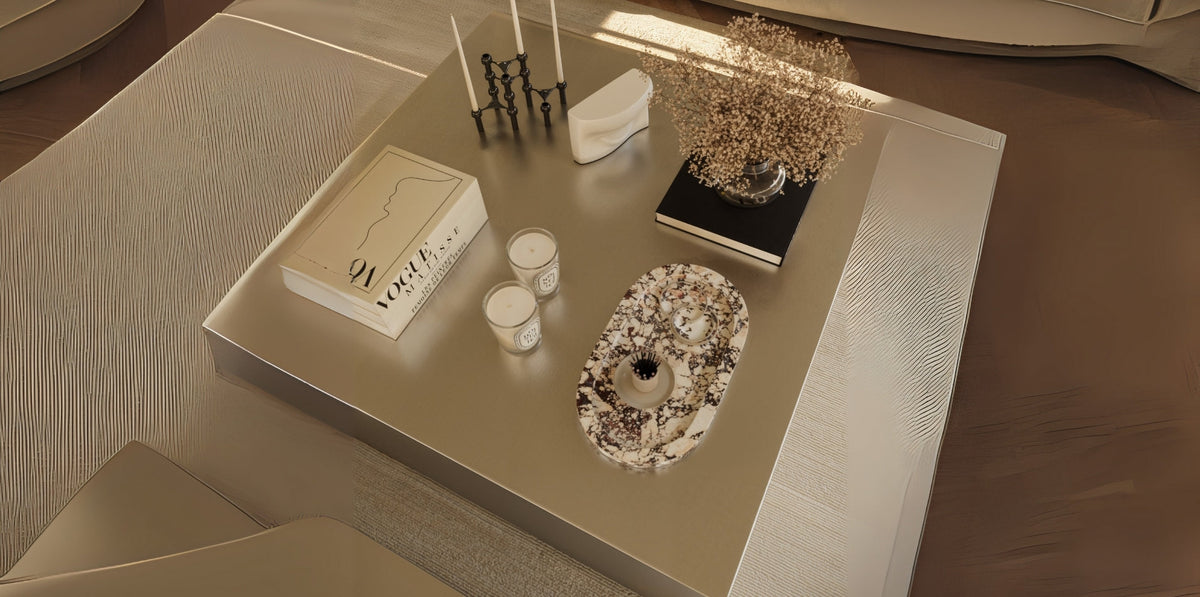 Square steel plinths styled as accent tables modern, paired with a linen sofa and contemporary lighting in a neutral interior.