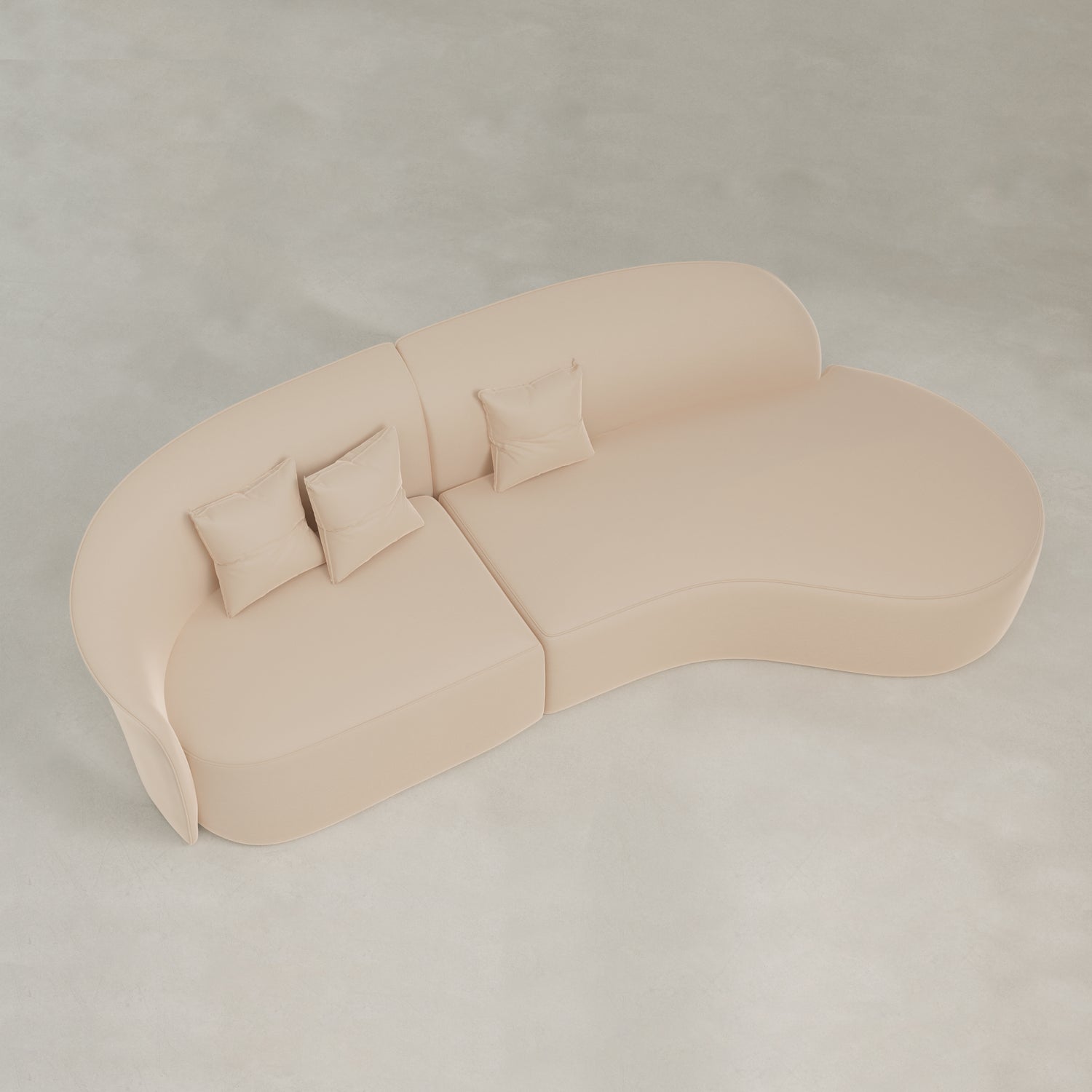 The Marlow Curved Modular Three Seater Sofa in beige velvet features a modern design with three matching square cushions, pictured from above on a light, smooth floor for a refined contemporary look.