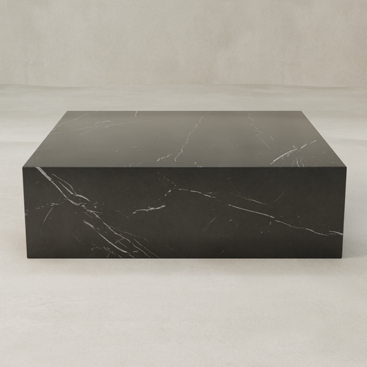The Obscara Coffee Table XL, a rectangular black marble plinth with subtle white veining, exudes timeless sophistication on a light neutral floor against a plain pale wall.
