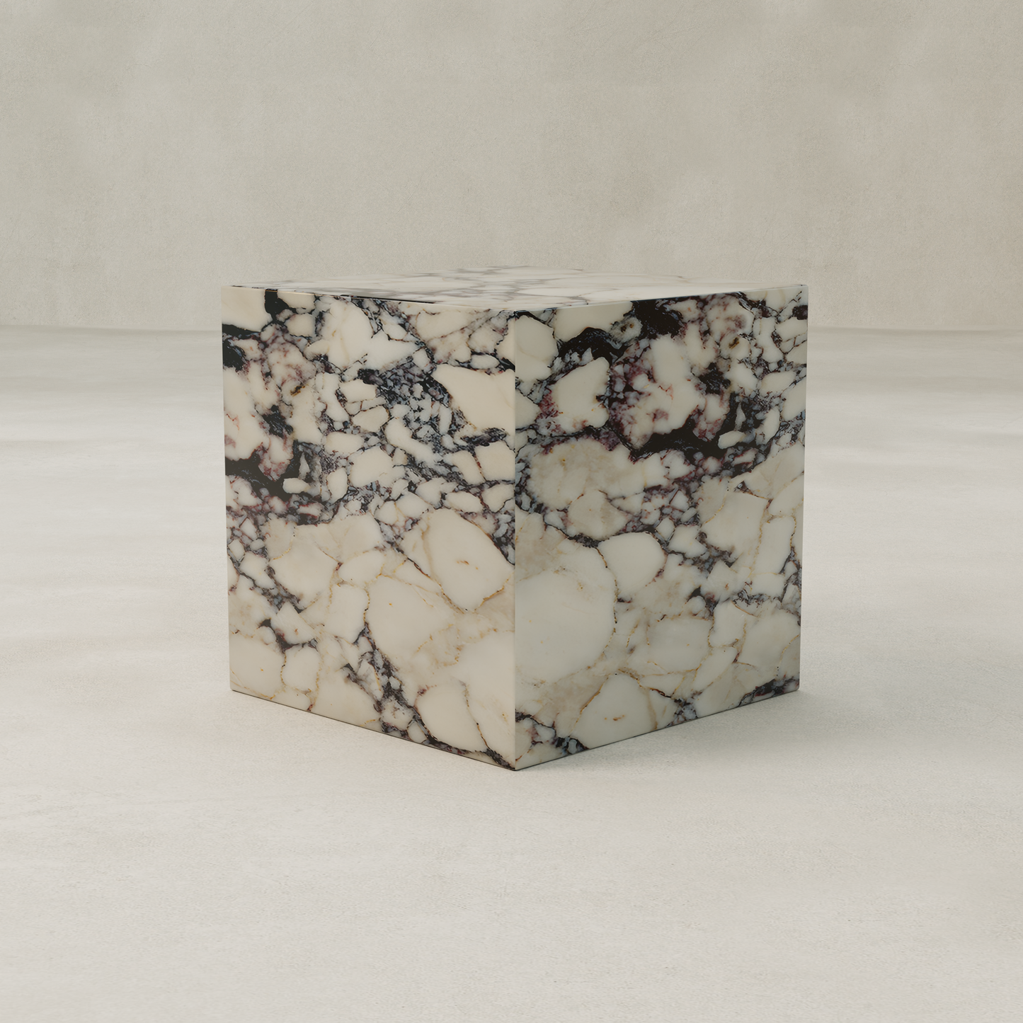 The Azurine Cube Plinth is a modern accent crafted from white marble with dark, irregular veining, displayed on a smooth, light-colored surface against a neutral background.