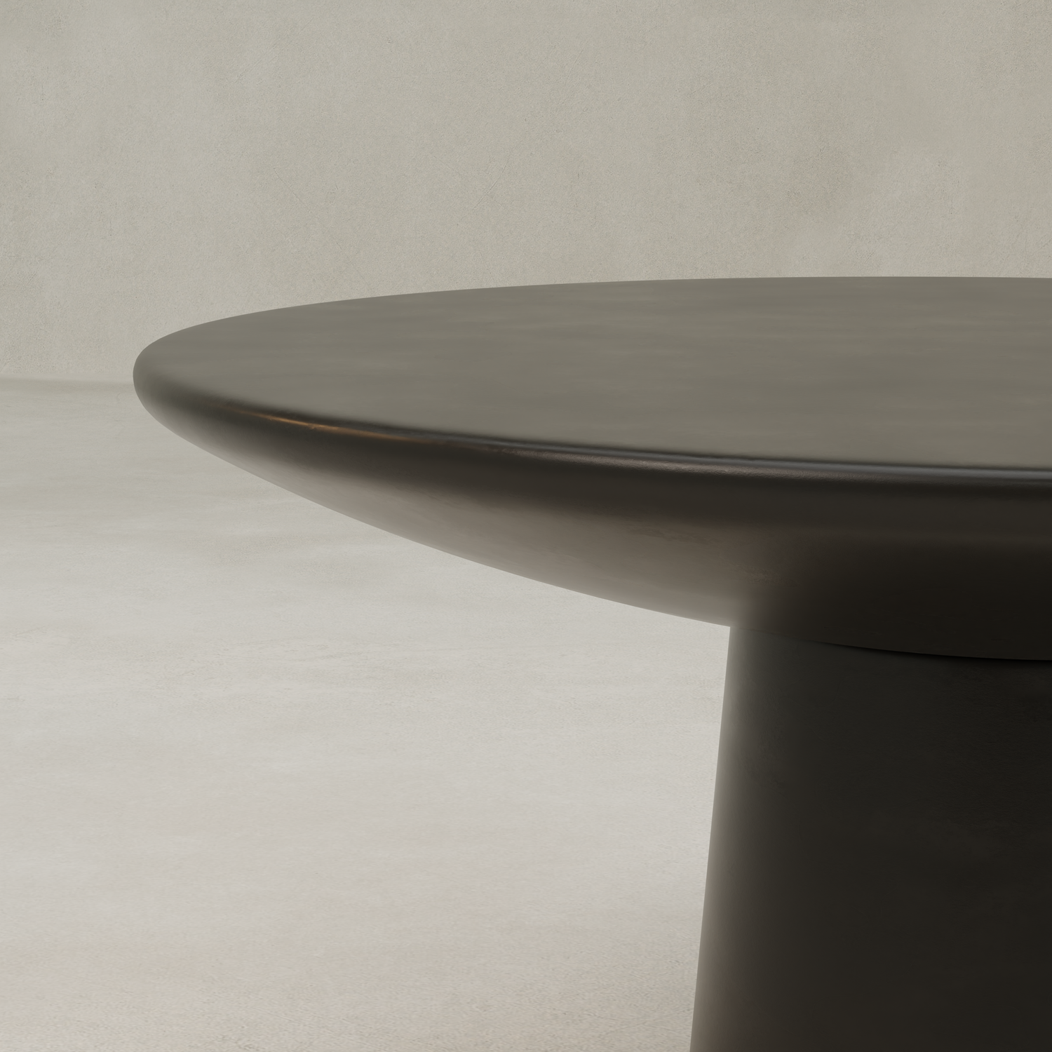 A close-up of the Arrio Table, featuring a thick circular top and sturdy central pedestal base, set against a neutral light gray background.
