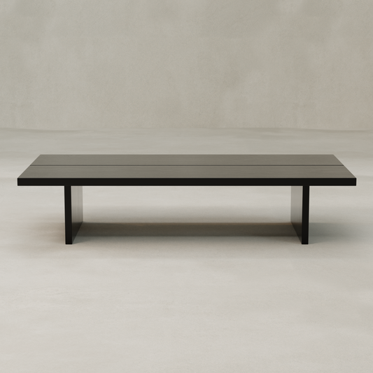 The Bastion Coffee Table showcases a minimalist rectangular design in solid pine, offering rustic charm with its dark finish and straight legs—perfect for neutral spaces with light flooring.