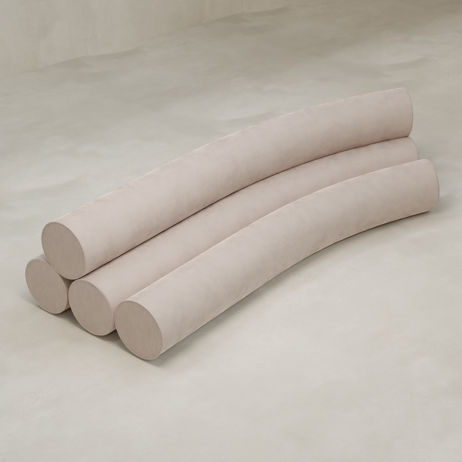 The Cylindra Sofa features four long, cylindrical, light beige cushions arranged in parallel, creating a modern curved silhouette on a smooth, neutral backdrop.