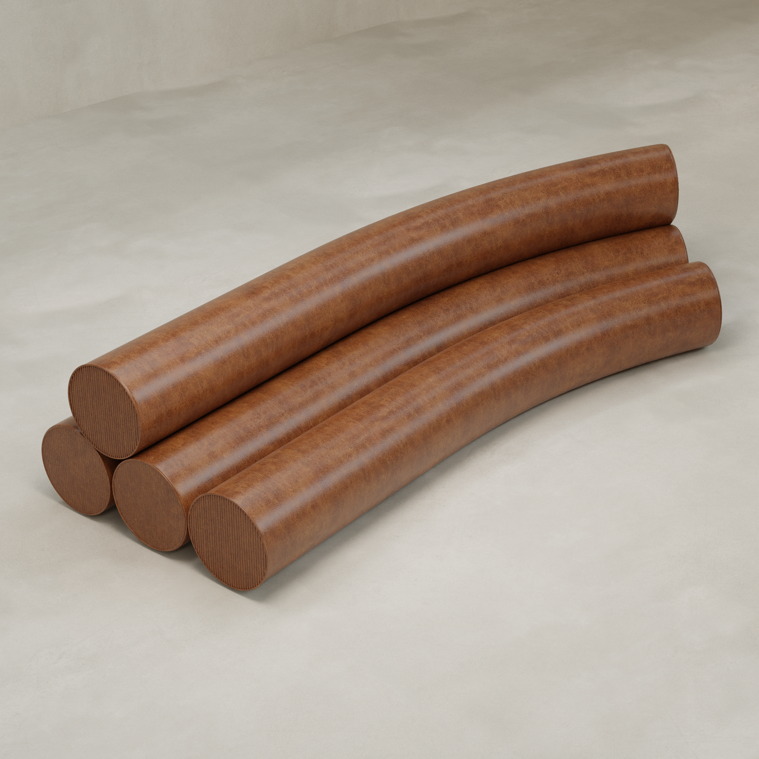 Four large, curved, brown Cylindra Sofa modules are stacked in two layers on a smooth, light surface, resembling oversized wooden beams in a minimalist setting.