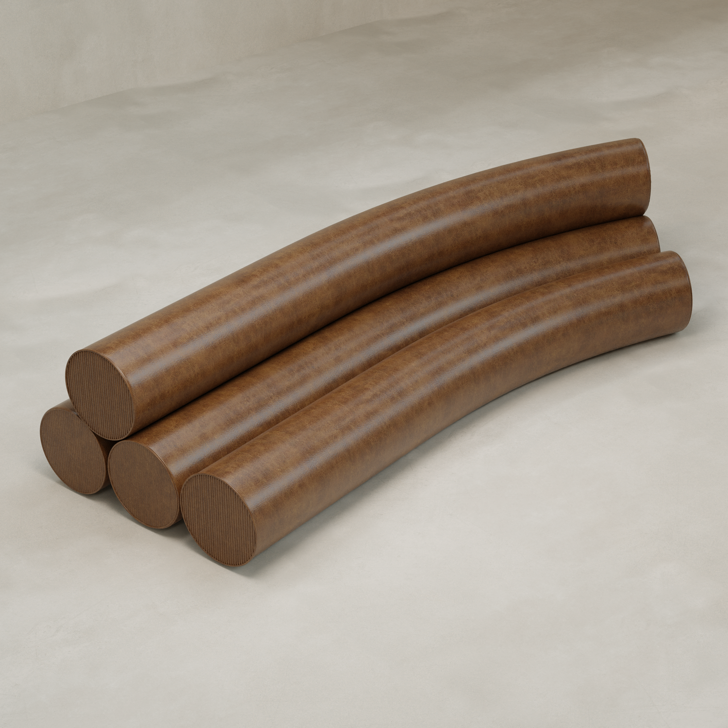 Four large, brown Cylindra Sofas with a smooth texture are stacked in a staggered arrangement on a light, neutral floor against a plain background, their gently curved shapes evoking playful, neotenic design.
