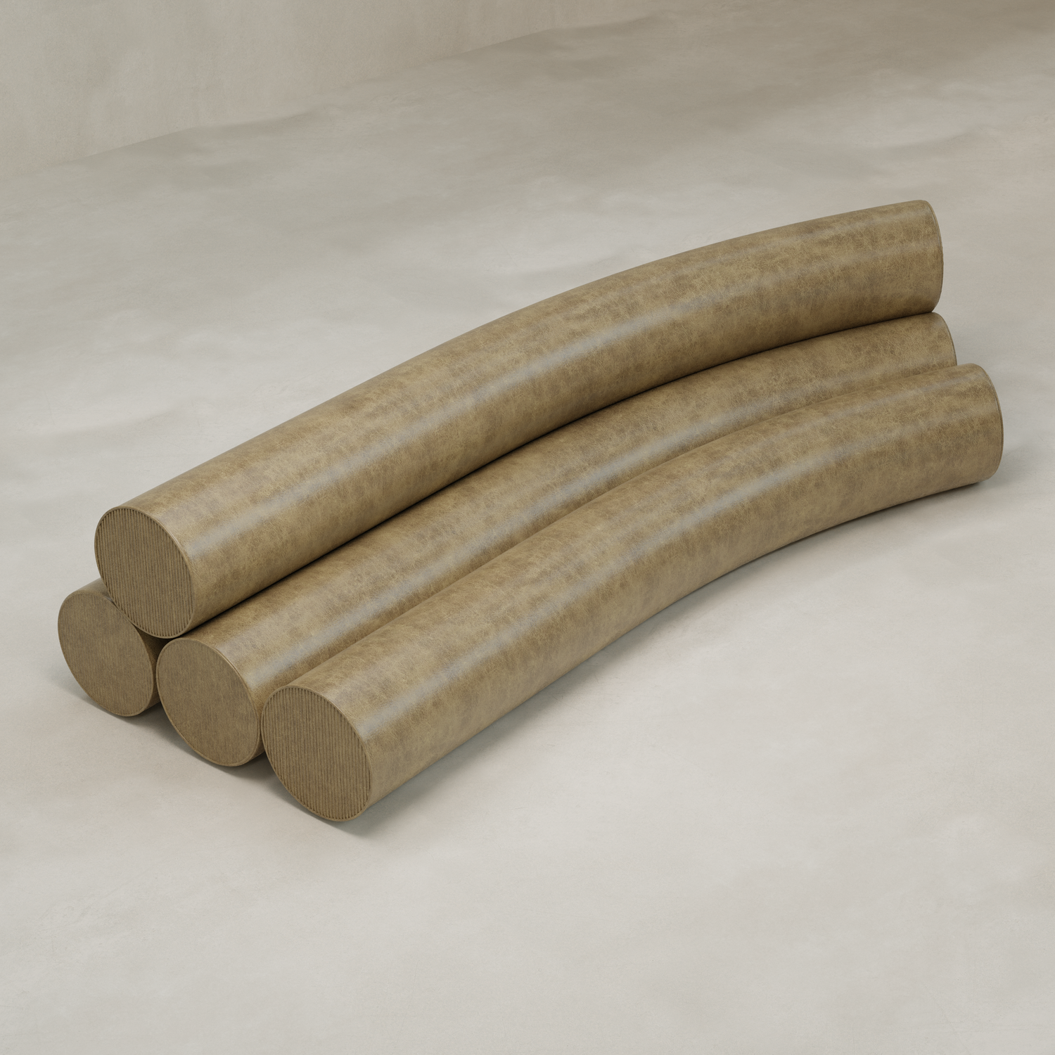 Four large, curved Cylindra Sofas with smooth, brownish surfaces are stacked on a light floor, evoking playful forms and soft lines in a minimalist, abstract composition.
