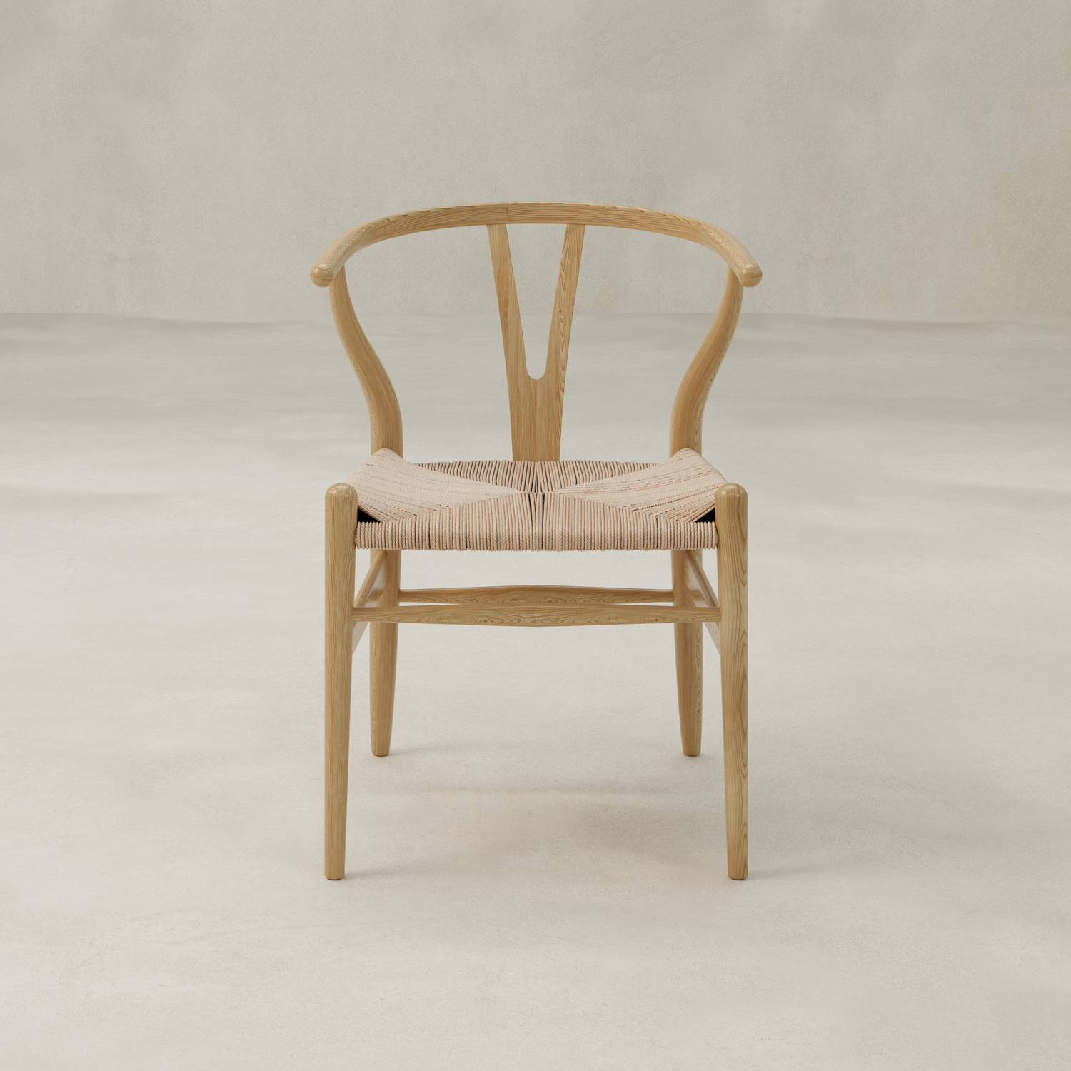 The Elsa Chair features a wooden Y-back, curved backrest, and woven seat. Its minimalist Scandinavian design suits any light, neutral space—ideal as a dining room chair for gatherings around a farmhouse table.