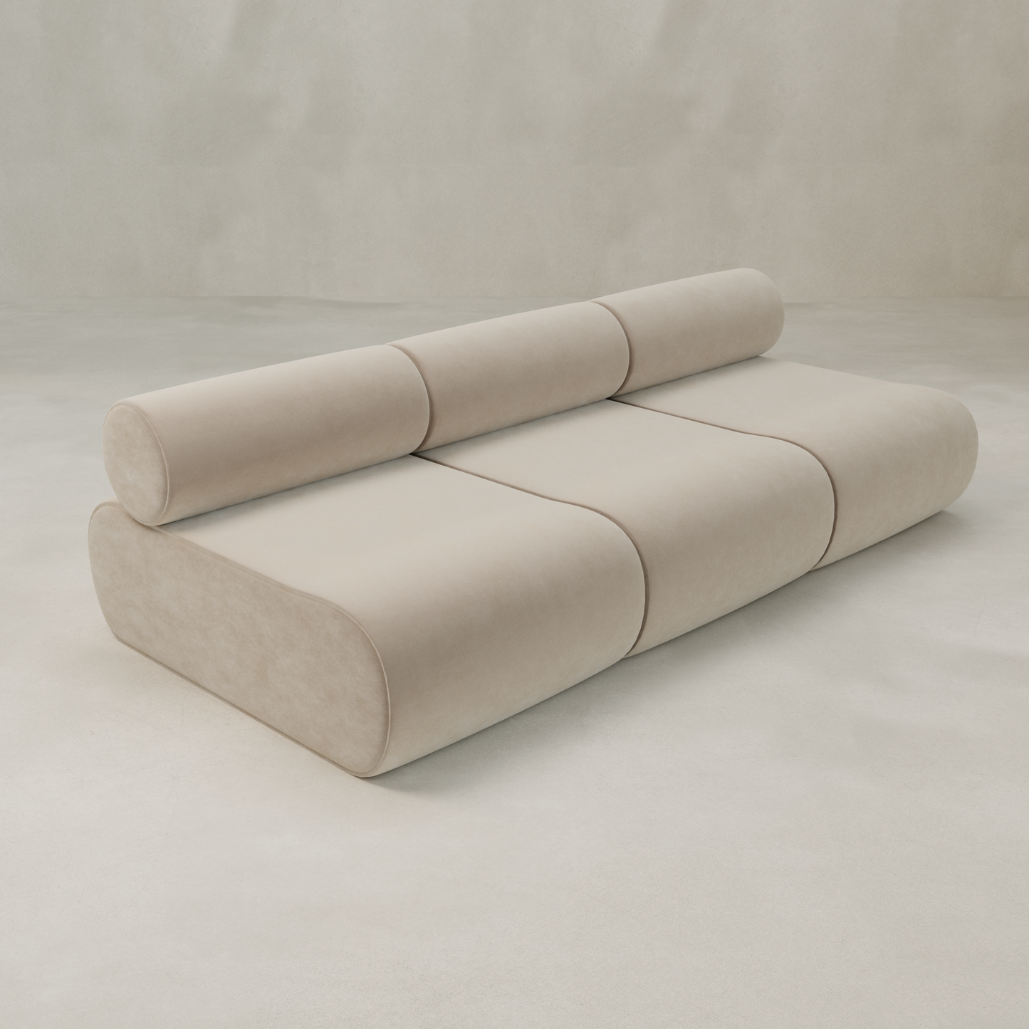 The Nuage Three Seater Modular Sofa features a modern, minimalist beige design with rounded edges, three seat sections, and a cylindrical backrest, shown against a plain light background.