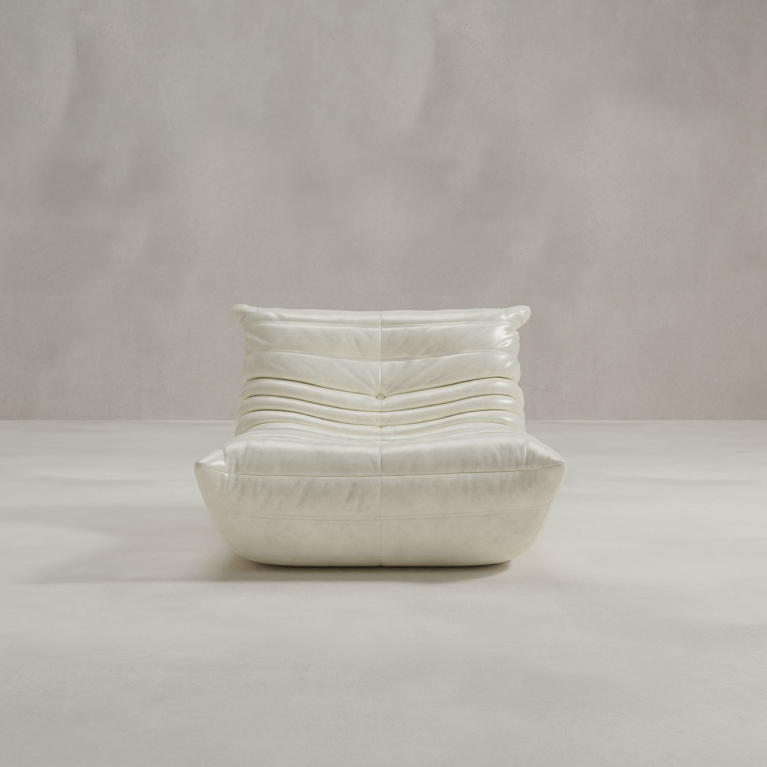 The Rolo Lounge Chair is a modern, low-profile white leather lounge chair with soft, gathered cushions and mid-century design cues, shown against a plain light gray textured background.