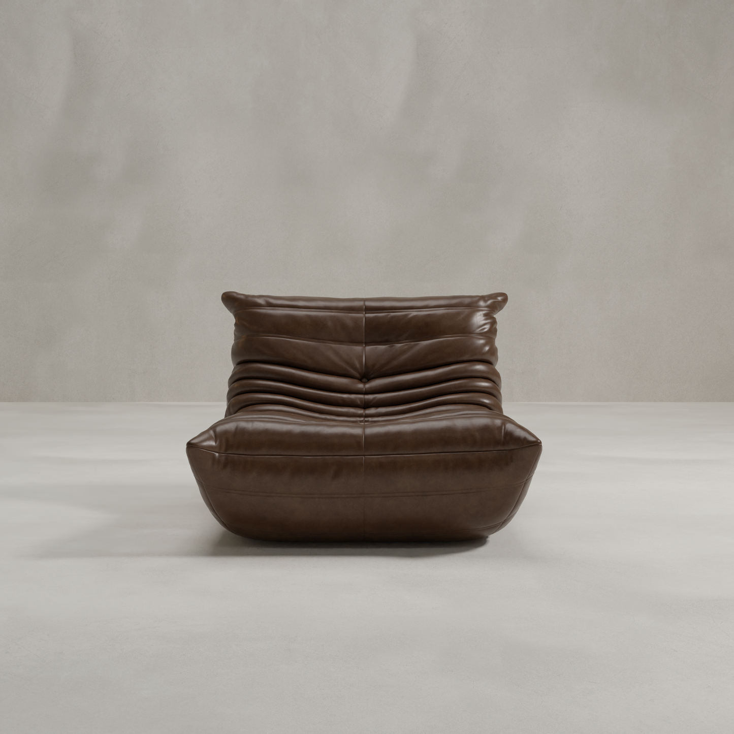 The Rolo Lounge Chair is a modern, armless brown leather lounge chair featuring a low seat and plush pleated cushioning, inspired by 70s design, shown against a plain light gray background.
