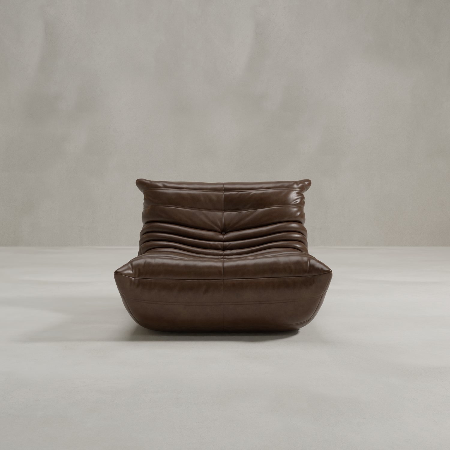 The Rolo Lounge Chair is a modern, armless brown leather lounge chair featuring a low seat and plush pleated cushioning, inspired by 70s design, shown against a plain light gray background.
