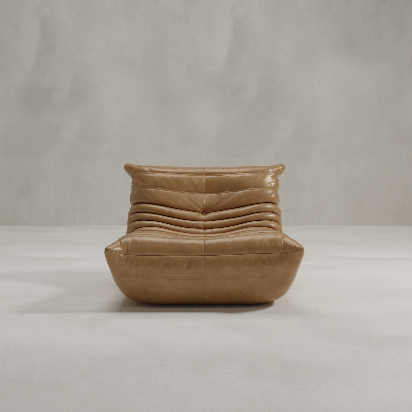 The Rolo Lounge Chair is a modern, low-profile tan leather seat with tufted cushions and mid-century design, showcased against a plain light gray background.