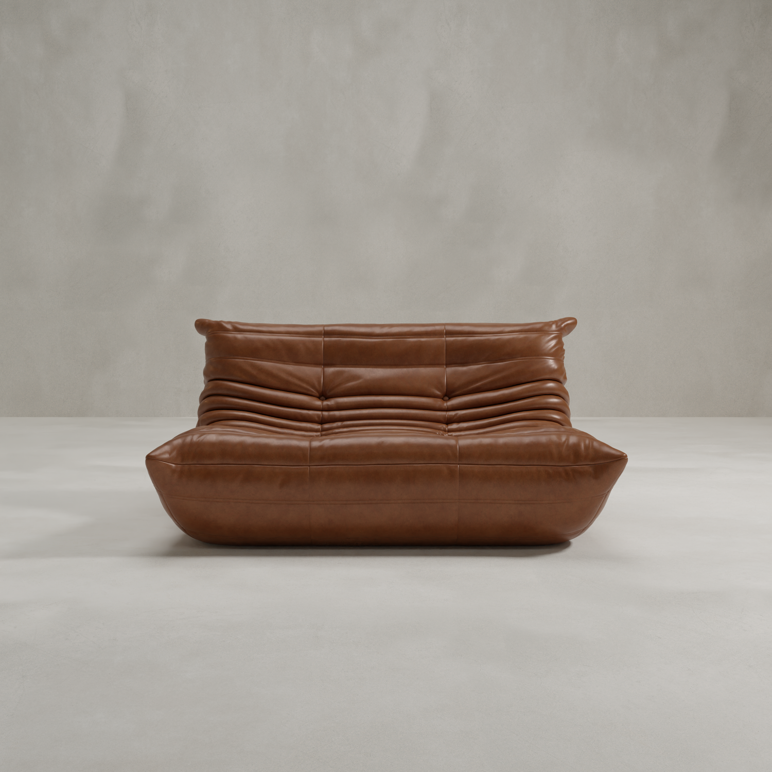 The Rolo Lounge Loveseat features a modern brown leather design with a low profile, deep seat, and ruched cushions inspired by mid-century style, showcased against a plain light gray background.