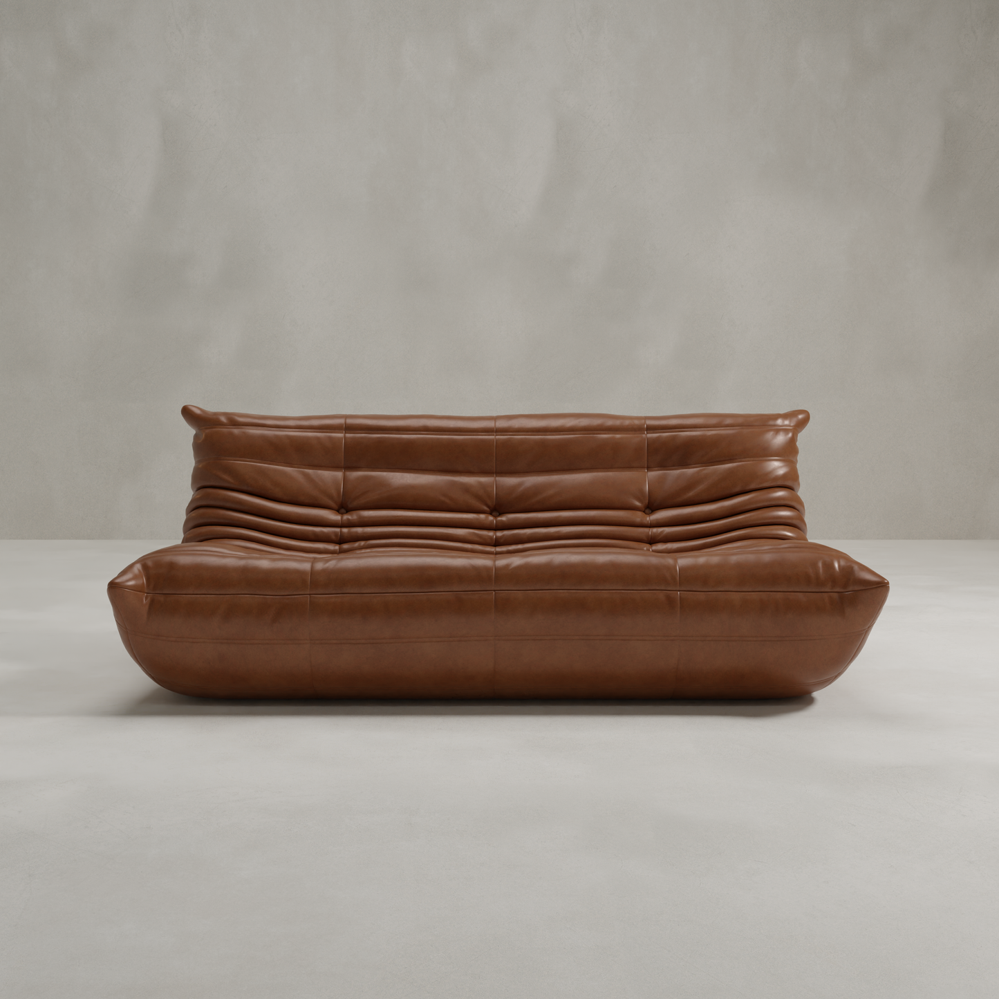 The Rolo Lounge Three Seater, a modern brown leather sofa with tufted seats and a plush, curved silhouette, brings mid-century flair to minimalist spaces with light gray textured walls and smooth floors.