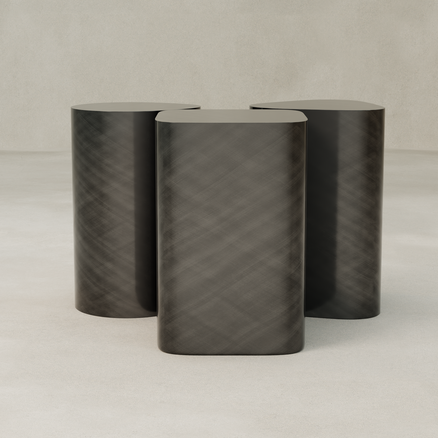 The Set of Solaris Side Tables features three dark, cylindrical tables with rounded tops, arranged closely on a smooth, light surface against a neutral background for a minimalist and modern luxury look.
