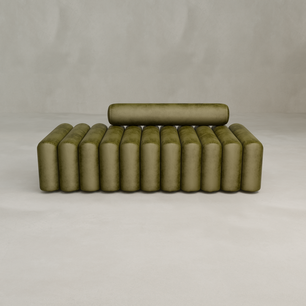 The Sonorra Bench Large is a minimalist olive green seat with a cylindrical backrest and evenly spaced vertical cushions in quilted velvet upholstery, shown against a plain light gray background.