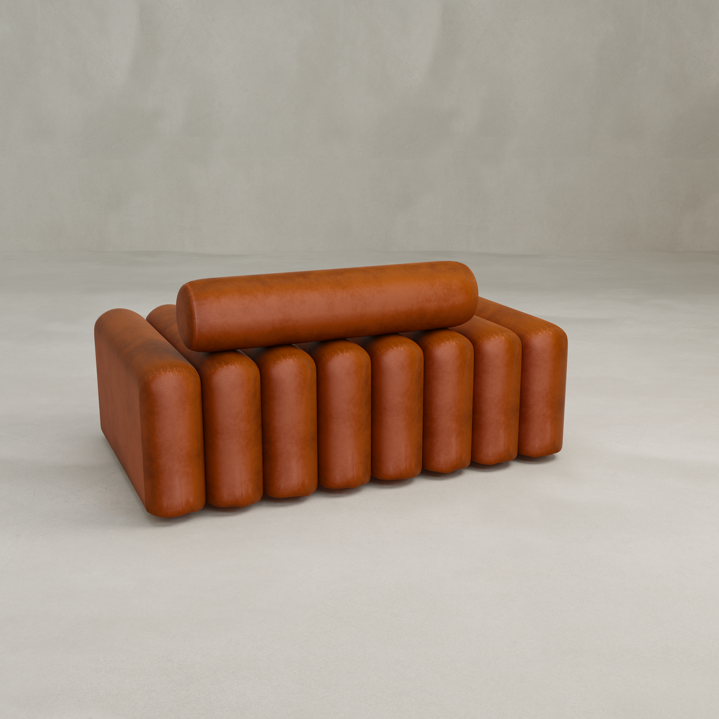 The Sonorra Bench Medium is a modern, minimalist brown leather sofa featuring a cylindrical backrest and evenly spaced vertical cushions, providing plush seating against a light gray backdrop.